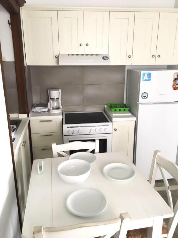 a kitchen with a table with two white plates on it at Thomas Traditional House in Chora in Amorgos