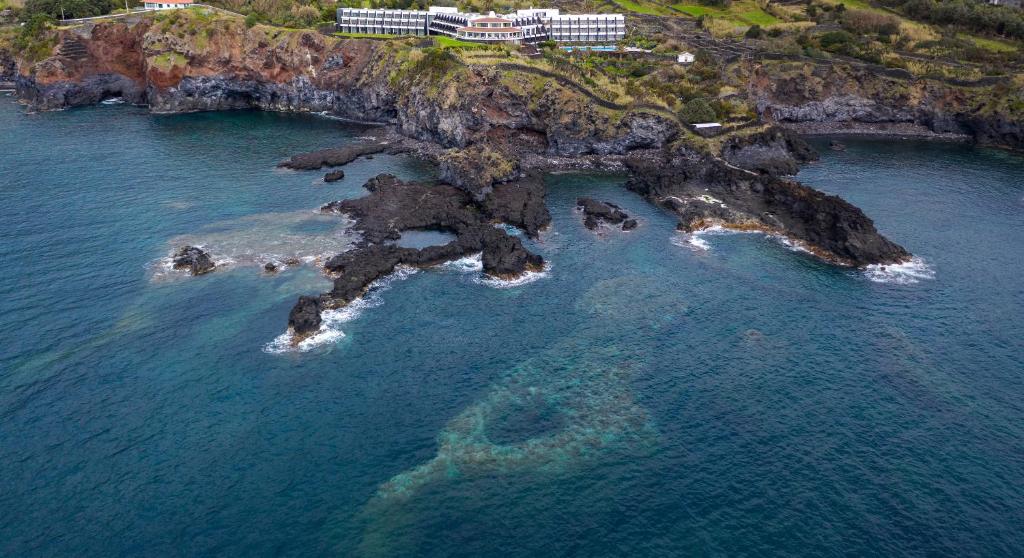 an aerial view of an island in the ocean at Caloura Hotel Resort in Caloura