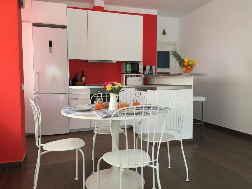 cocina con mesa, sillas y nevera en Nice apartment 80 meters from the beach, en Calafell