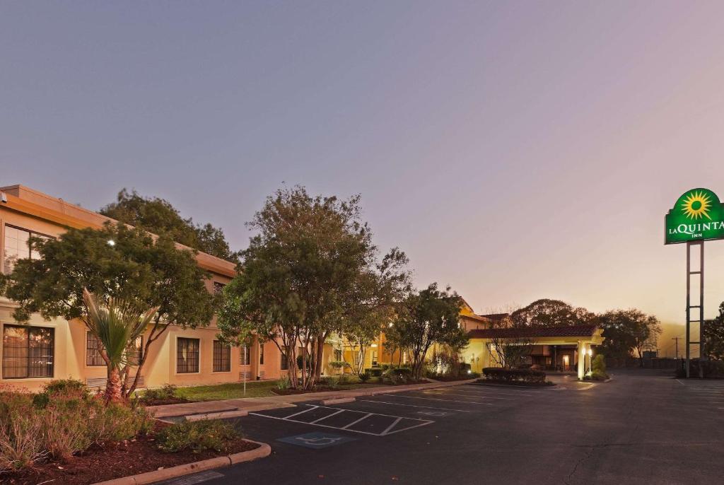 an empty parking lot in front of a hotel at La Quinta Inn by Wyndham Austin Oltorf in Austin