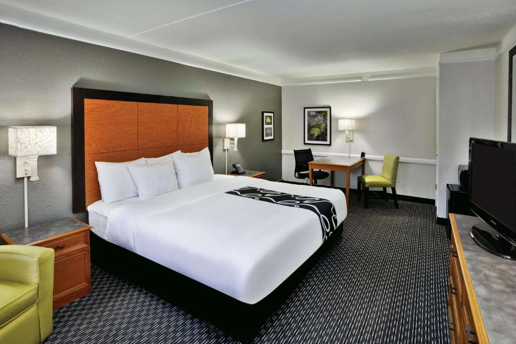 a hotel room with a large bed and a television at La Quinta Inn by Wyndham Nashville South in Nashville