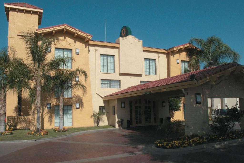 um edifício com uma palmeira em frente em La Quinta Inn by Wyndham Bakersfield South em Bakersfield