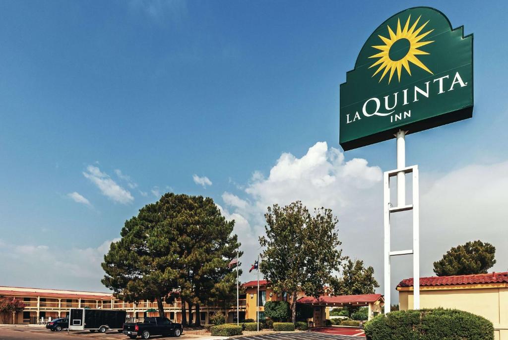 a sign for a la union inn in a parking lot at La Quinta Inn by Wyndham and Conference Center San Angelo in San Angelo