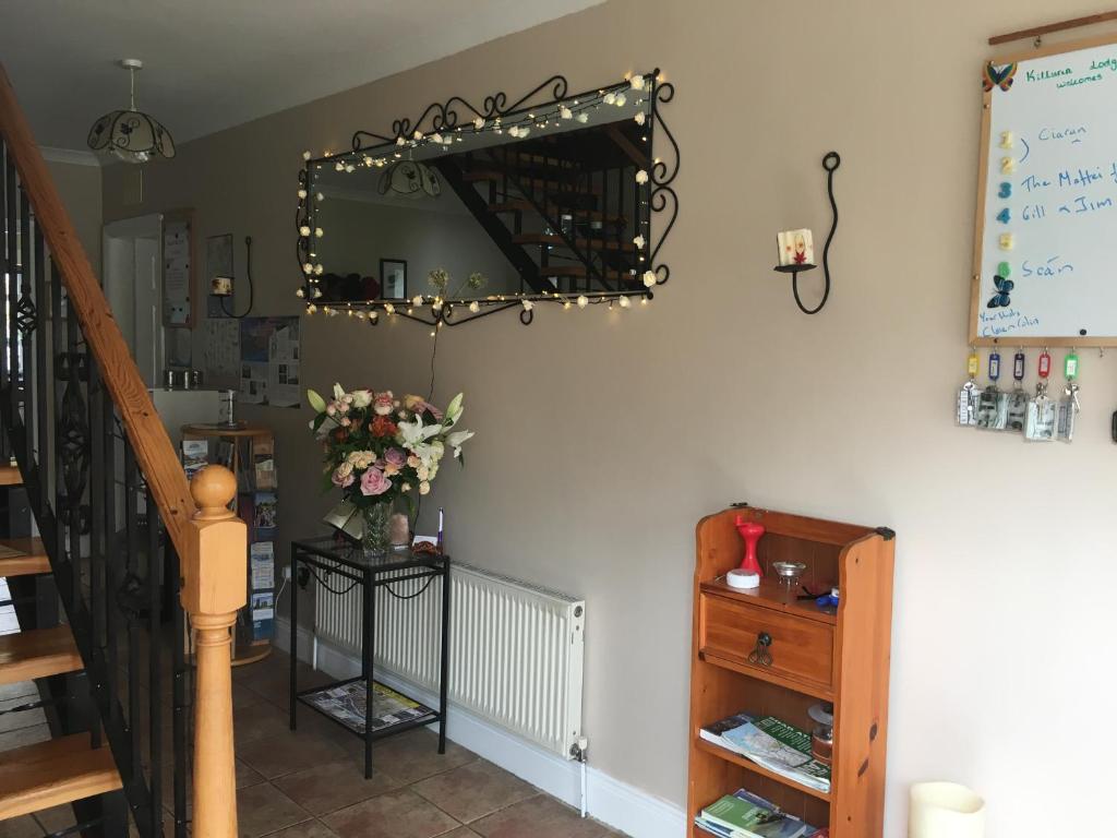 a room with a staircase and a mirror on the wall at Killurin Lodge in Wexford