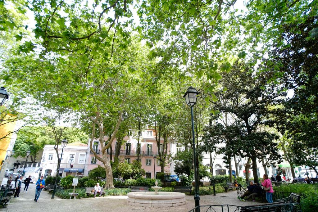 a park with a bench and a street light at Bright And Sunny Apartment in Lisbon