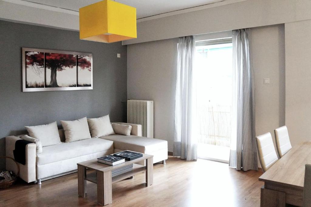 a living room with a couch and a table at Comfy Apartment With Acropolis View in Athens