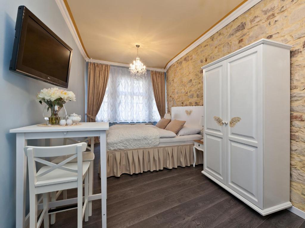 a bedroom with a bed and a dresser at Cathedral Prague Apartments in Prague