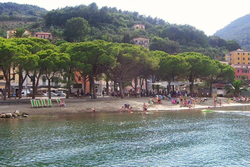 a group of people on a beach near a body of water at Brezza Marina in Portovenere