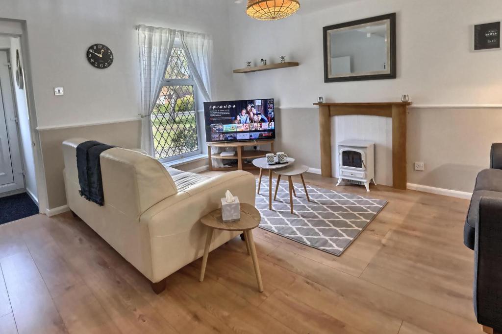 a living room with a couch and a tv at 52 Minster in Beverley