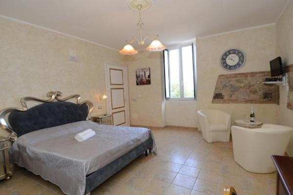 a bedroom with a bed and a bathtub and a bathroom at Residenza Casale San Francesco free parking in Tropea