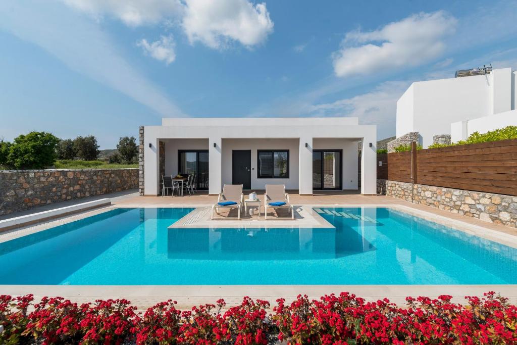 a villa with a swimming pool and a house at Prasonisi Villas in Kattavía