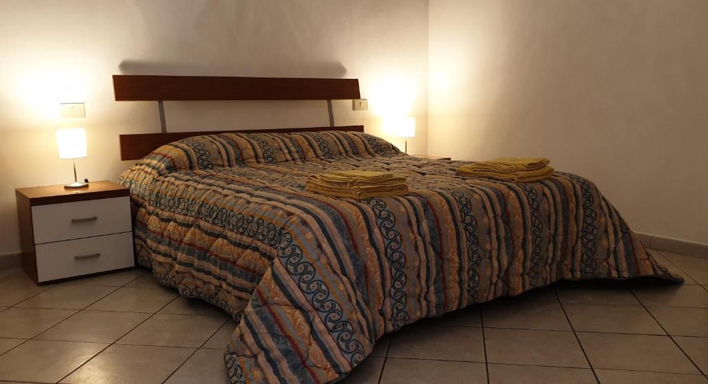 a bedroom with a bed with a blanket on it at Ladybug Apartment in Poggibonsi