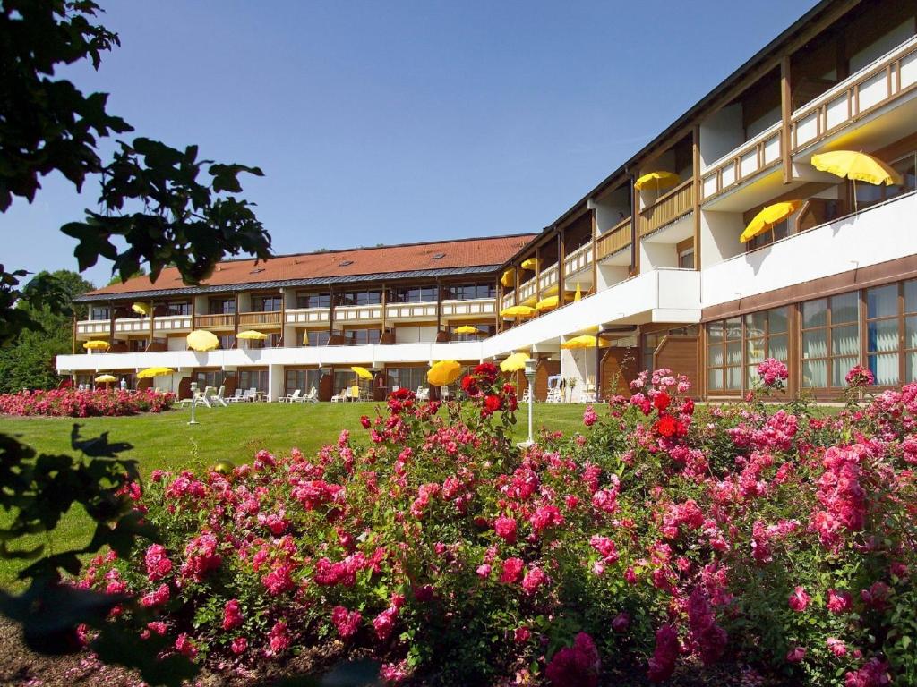 duży budynek z różowymi kwiatami przed nim w obiekcie Apart Hotel am Sonnenhügel w mieście Bad Birnbach