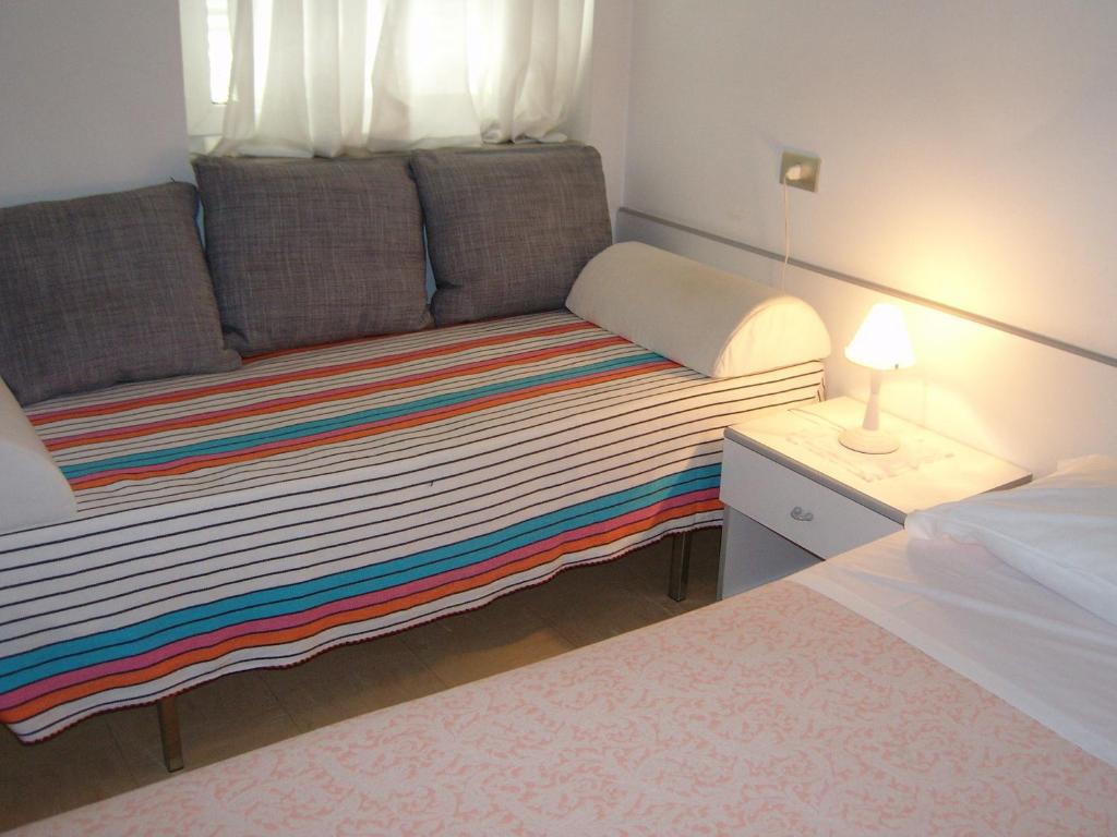 Postel nebo postele na pokoji v ubytování Hotel Villa Carla