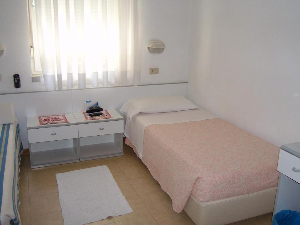 Postel nebo postele na pokoji v ubytování Hotel Villa Carla