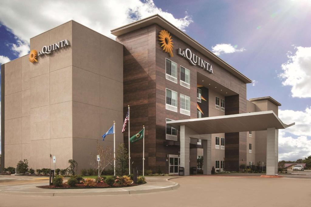 a large building with a sunflower sign on it at La Quinta by Wyndham Mobile in Mobile