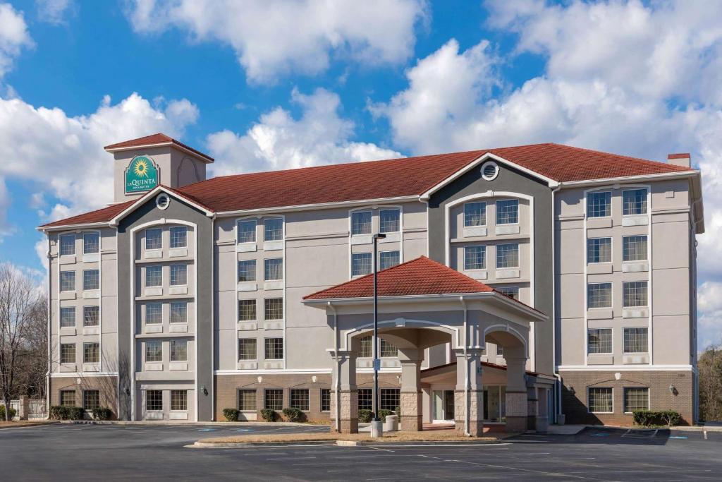 a large building with a clock tower on top of it at La Quinta by Wyndham Atlanta Douglasville in Douglasville