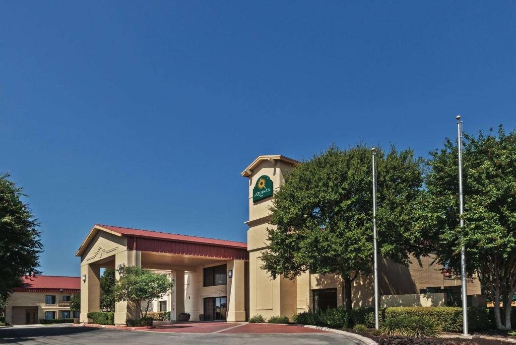 a building with a clock tower on the side of it at La Quinta Inn by Wyndham San Marcos in San Marcos