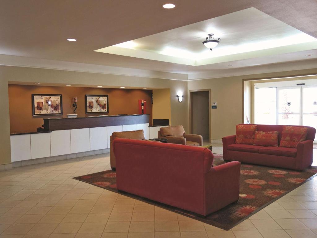 a lobby with couches and a bar in a hospital at La Quinta by Wyndham Seguin in Seguin