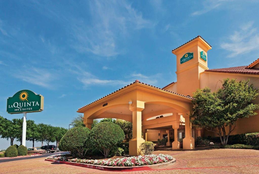 a building with a clock tower on top of it at La Quinta by Wyndham Dallas DFW Airport North in Irving