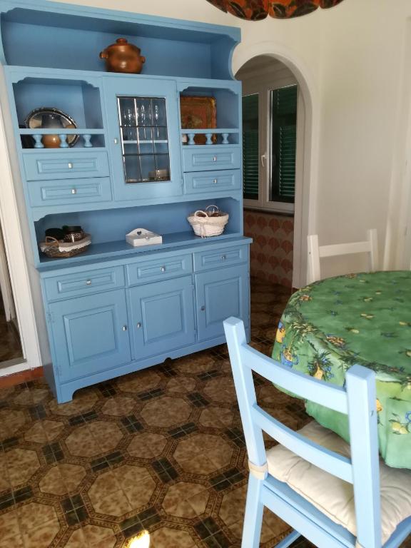 a blue cabinet in a room with a table and chairs at casa fiorella in San Bernardino
