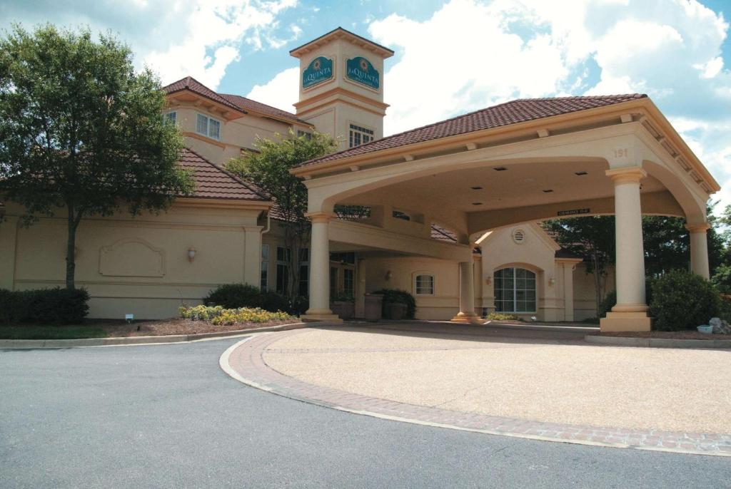 a large building with a clock tower on top of it at La Quinta by Wyndham Raleigh Cary in Cary