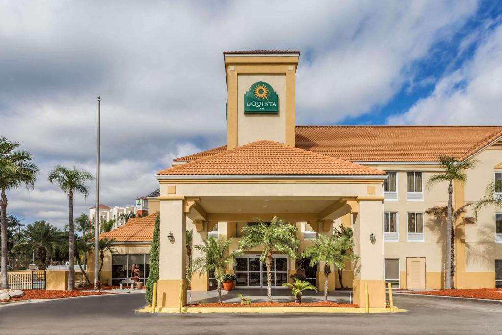 a large building with a clock on the front of it at La Quinta by Wyndham Orlando Universal area in Orlando