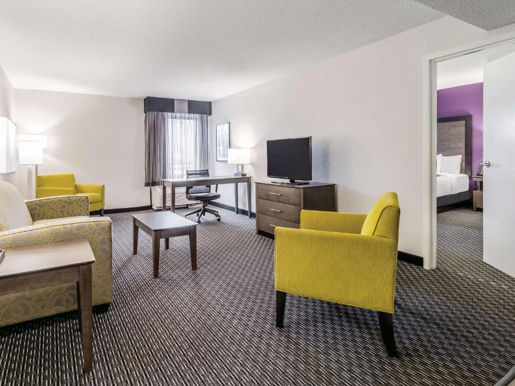 a hotel room with yellow chairs and a living room at La Quinta by Wyndham Myrtle Beach - N. Kings Hwy in Myrtle Beach