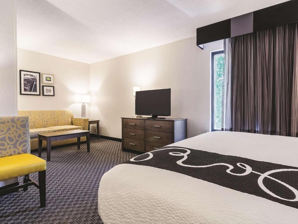 a hotel room with a bed and a tv at La Quinta by Wyndham Myrtle Beach - N. Kings Hwy in Myrtle Beach