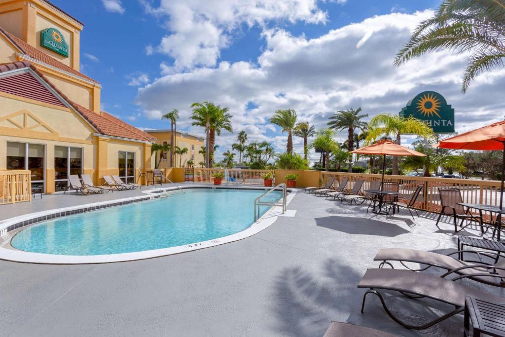 
a beach with a pool and a pool table at La Quinta by Wyndham Orlando Universal area in Orlando
