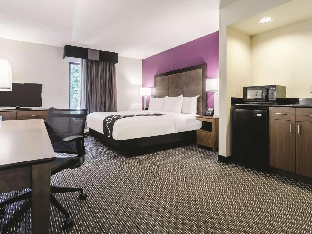 a hotel room with a bed and a desk at La Quinta by Wyndham Myrtle Beach - N. Kings Hwy in Myrtle Beach