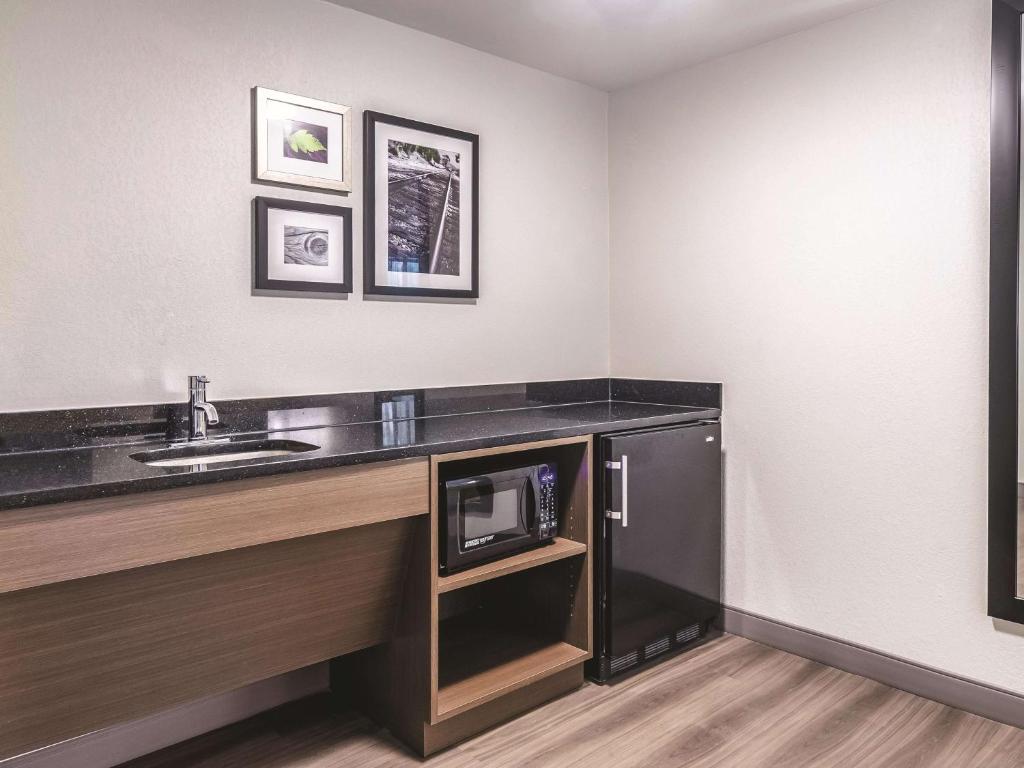 a bathroom with a sink and a microwave at La Quinta by Wyndham Myrtle Beach - N. Kings Hwy in Myrtle Beach