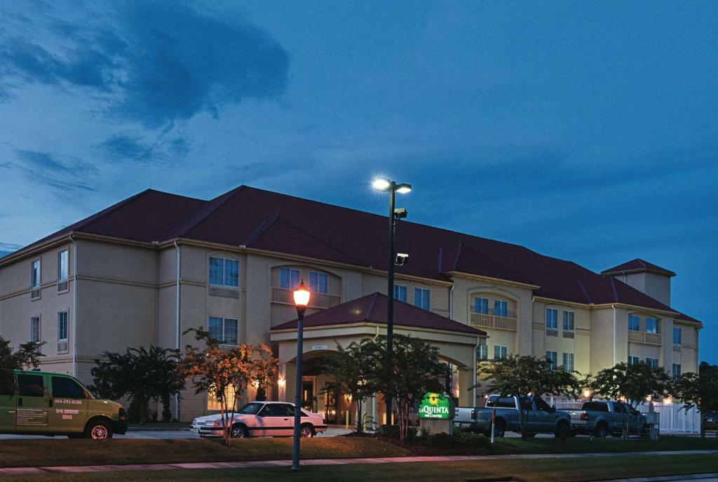 a hotel building with cars parked in front of it at La Quinta by Wyndham Slidell - North Shore Area in Slidell