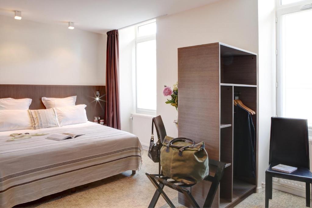 Postel nebo postele na pokoji v ubytování Hôtel Le Benhuyc