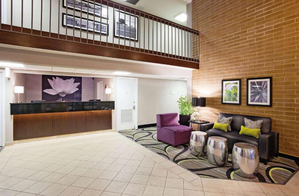 a lobby of a hotel with a couch and chairs at La Quinta Inn by Wyndham Oshkosh in Oshkosh