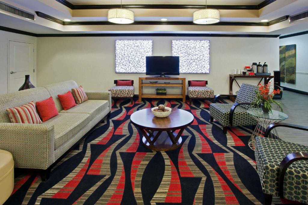a living room with a couch and a table at La Quinta by Wyndham Conway in Conway