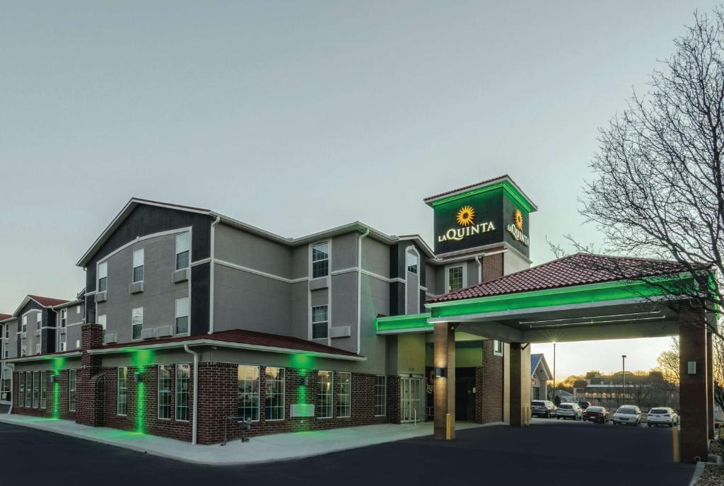 a rendering of a hotel with a gas station at La Quinta by Wyndham Kansas City Airport in Kansas City