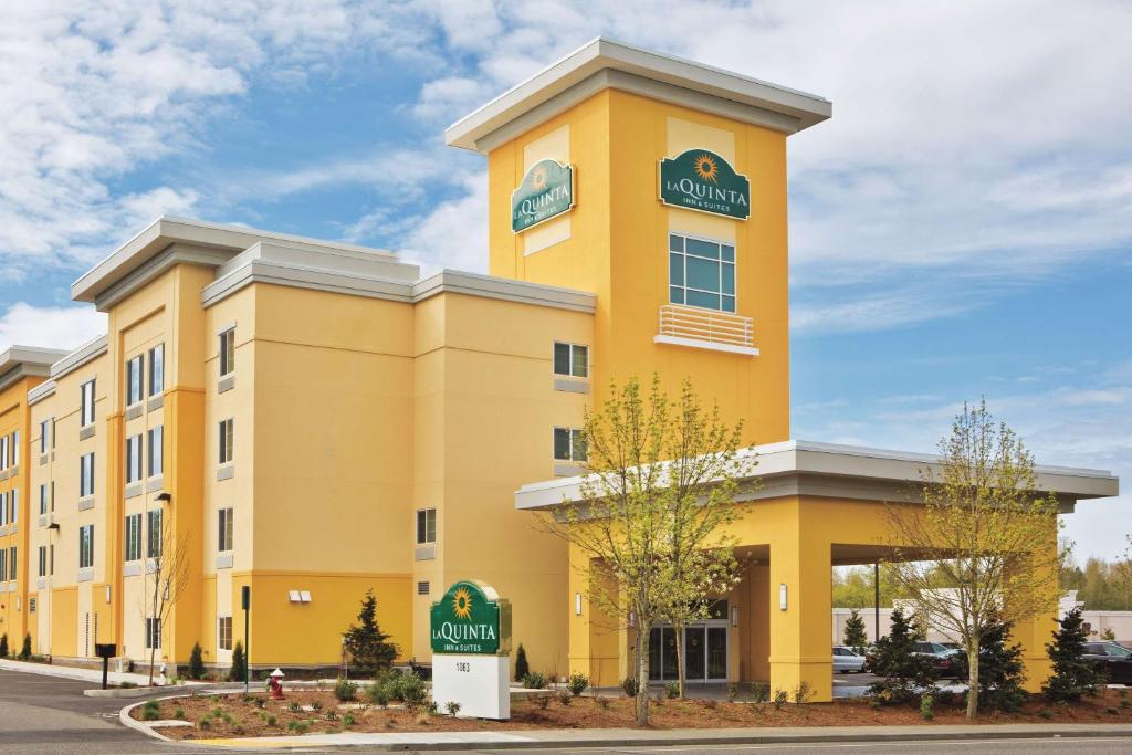 a yellow building with a clock on top of it at La Quinta by Wyndham Bellingham in Bellingham