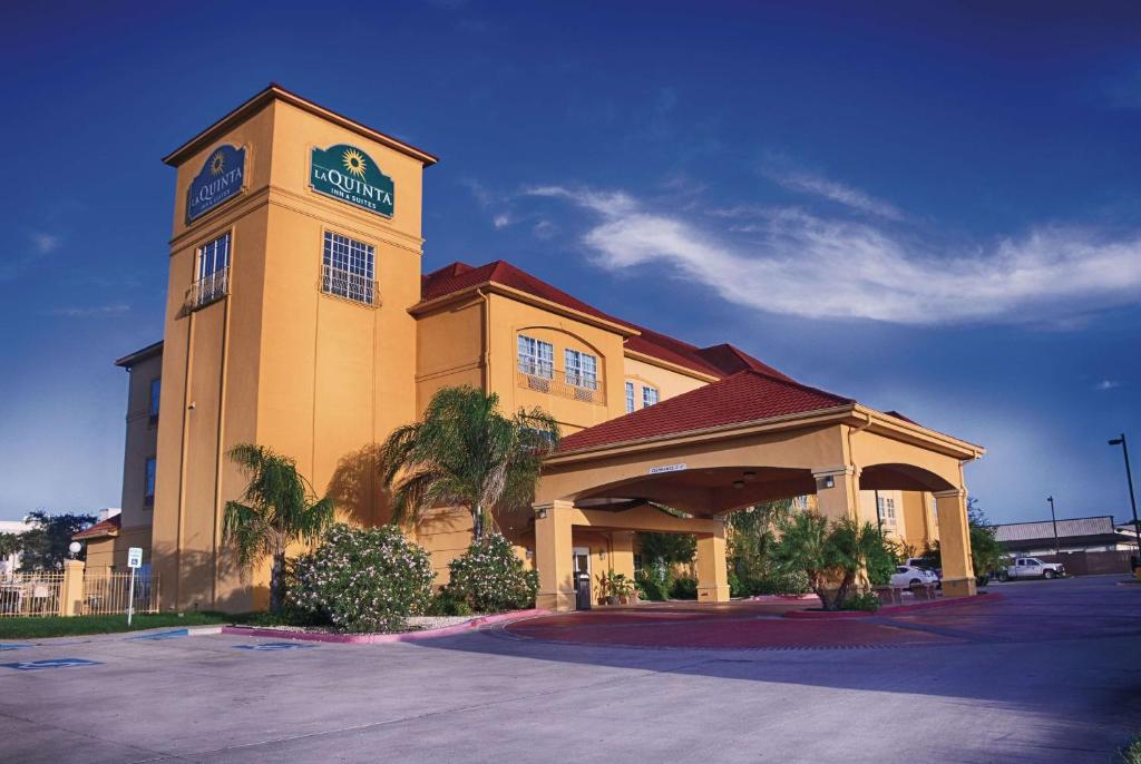 a building with a clock tower in a parking lot at La Quinta by Wyndham Alice in Alice