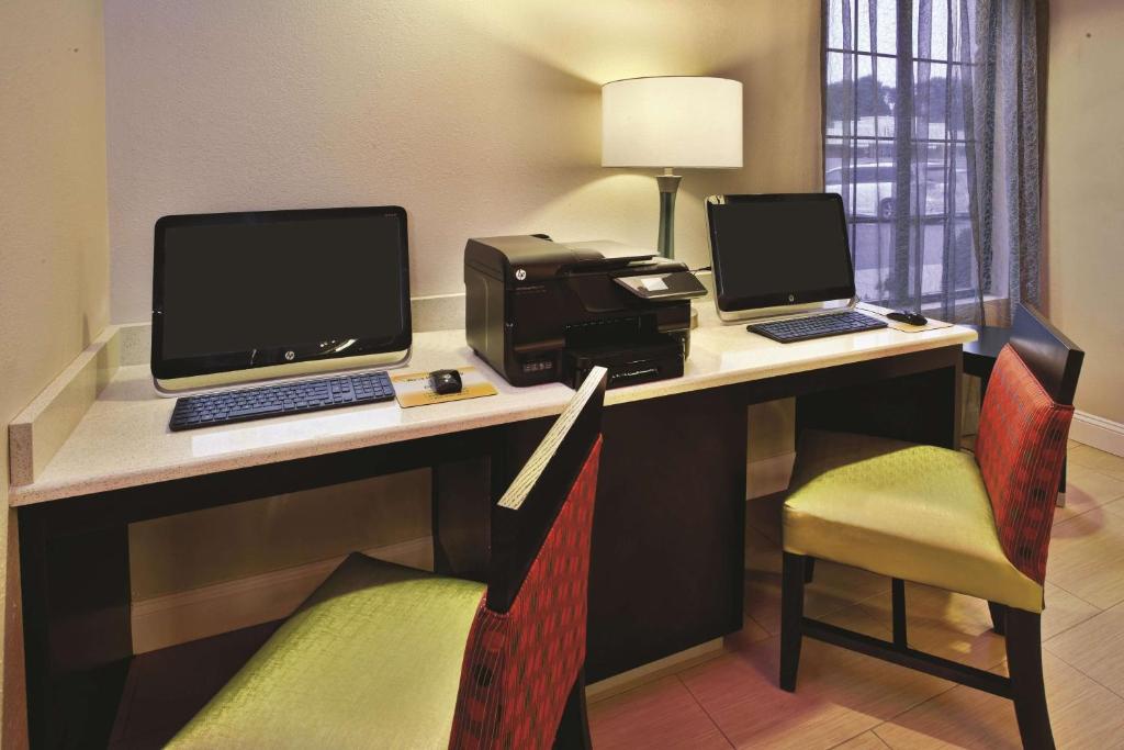 a room with a desk with a computer and a printer at La Quinta Inn & Suites - New River Gorge National Park in Summersville