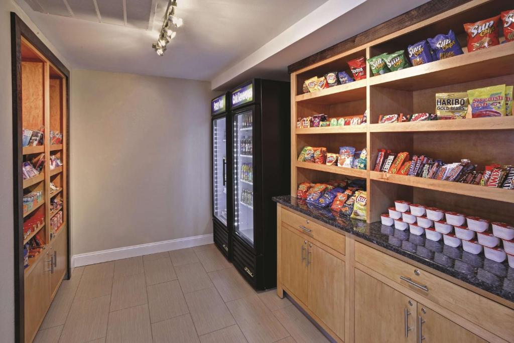a walk in pantry with lots of shelves at La Quinta Inn & Suites - New River Gorge National Park in Summersville