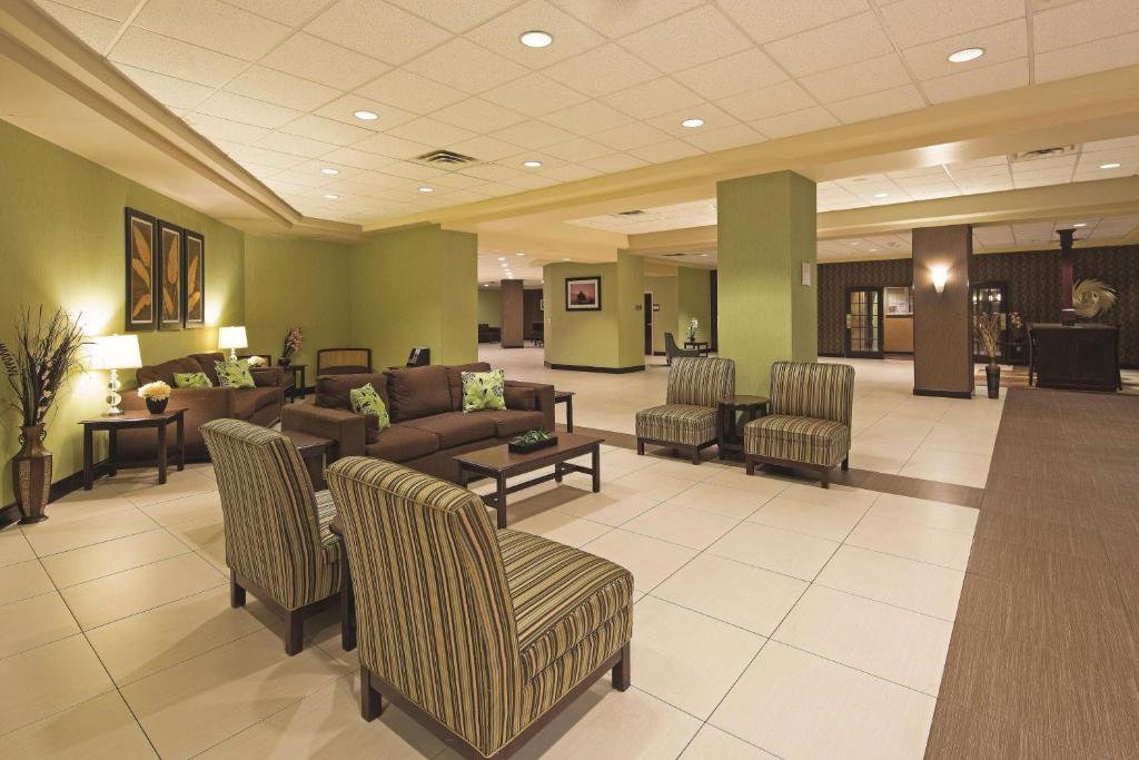 a lobby with a waiting room with couches and chairs at La Quinta by Wyndham Salisbury in Salisbury