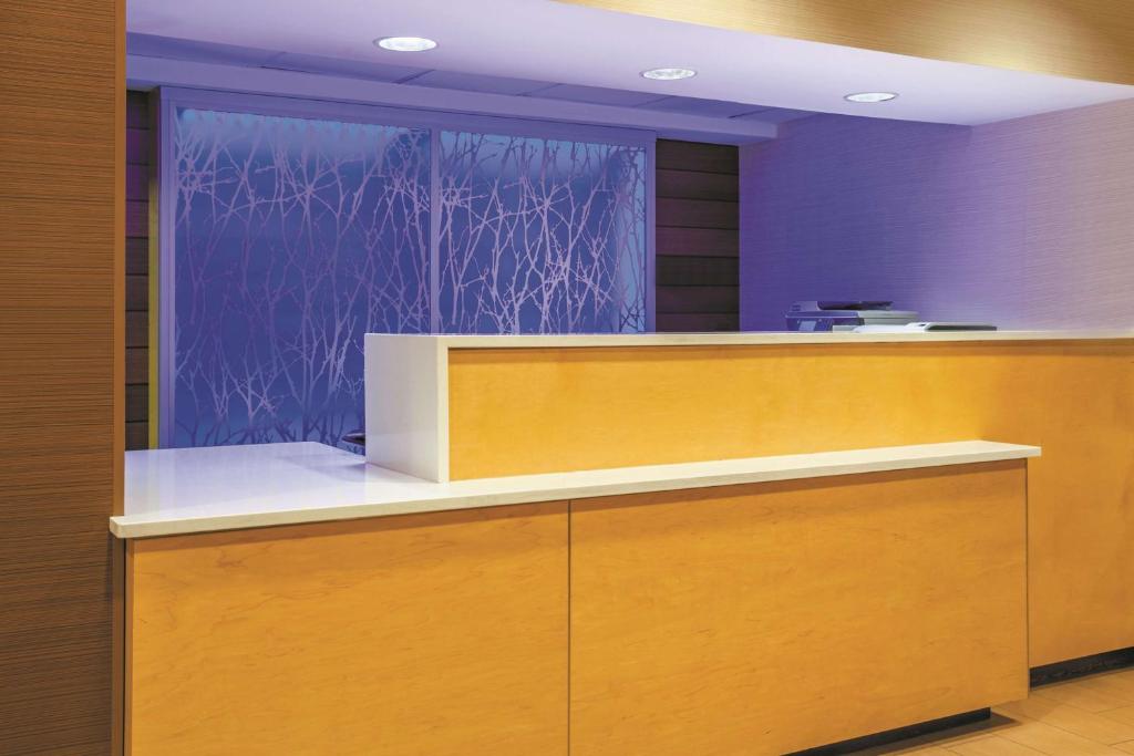 an office with a reception counter with a blue wall at La Quinta by Wyndham Manassas Battlefield in Manassas