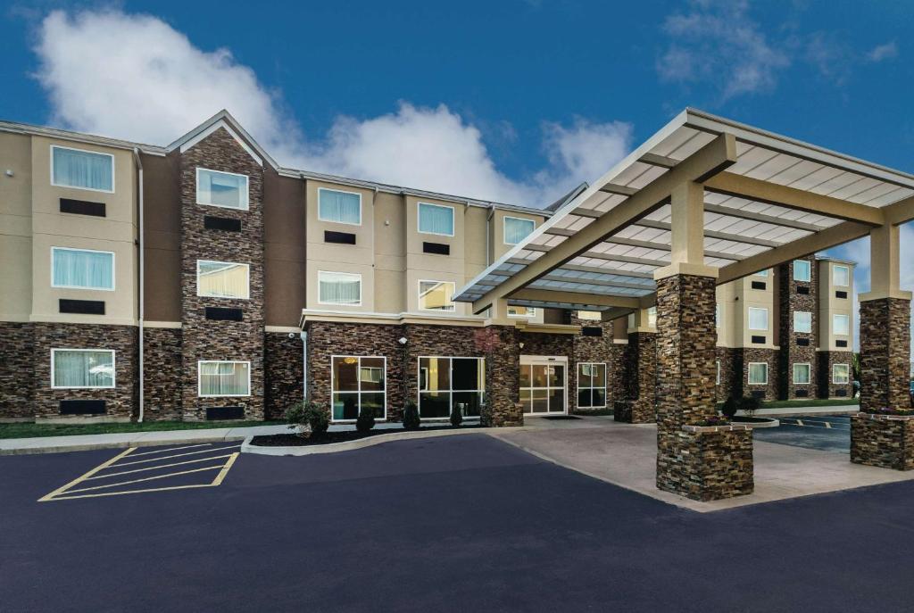 a rendering of a hotel with a large building at La Quinta by Wyndham Collinsville - St. Louis in Collinsville