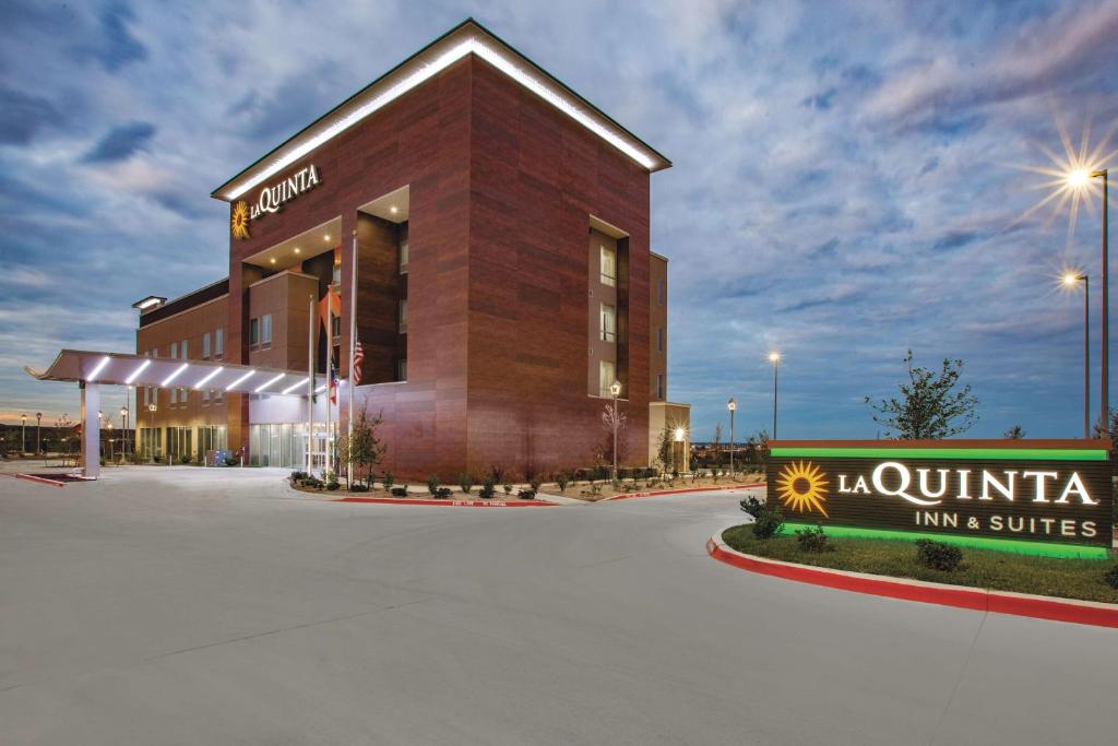 a large building with a clock on the side of it at La Quinta by Wyndham San Marcos Outlet Mall in San Marcos