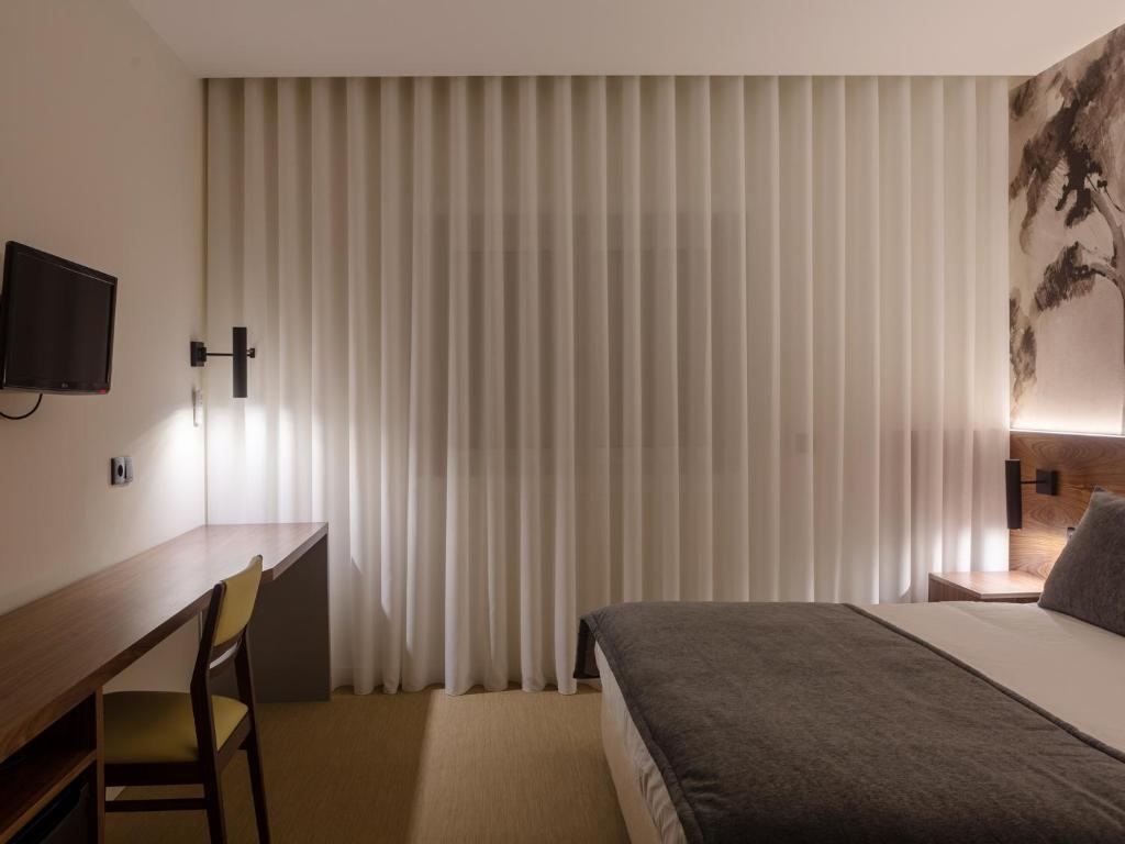 Postel nebo postele na pokoji v ubytování Hotel Afonso V & SPA