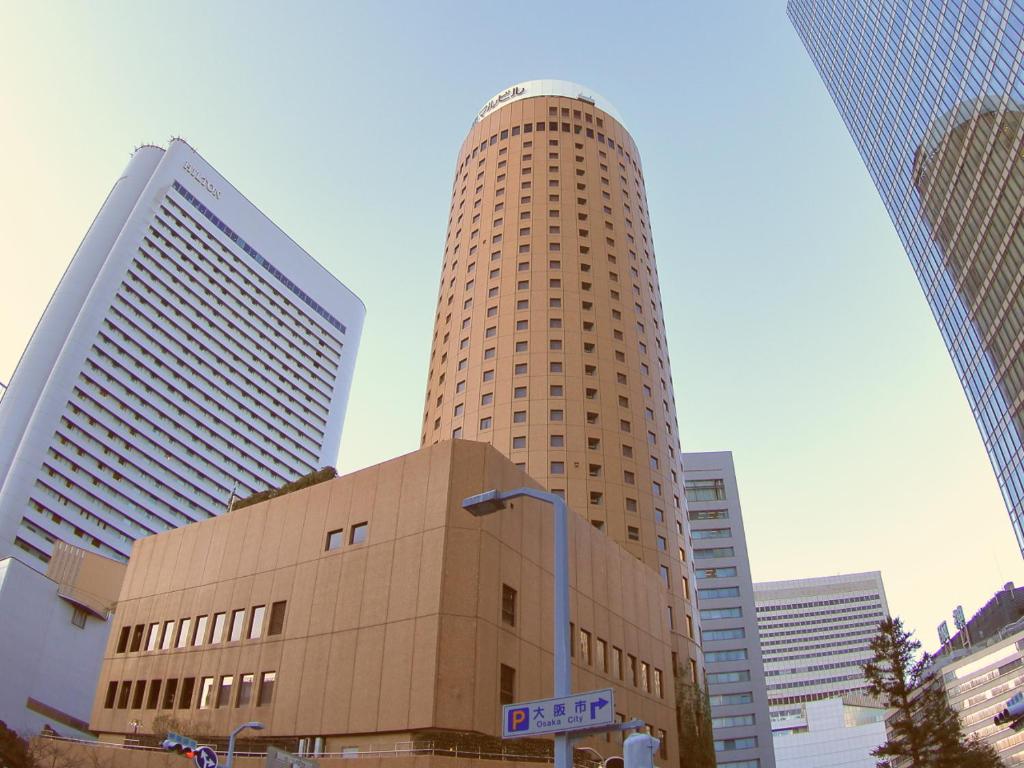 a tall building with a large clock tower at Osaka Dai-ichi Hotel in Osaka