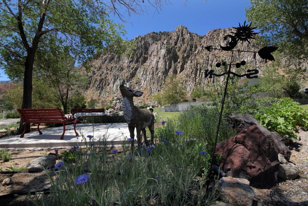 a statue of a deer standing in a garden at Meadowcliff Lodge Coleville in Coleville
