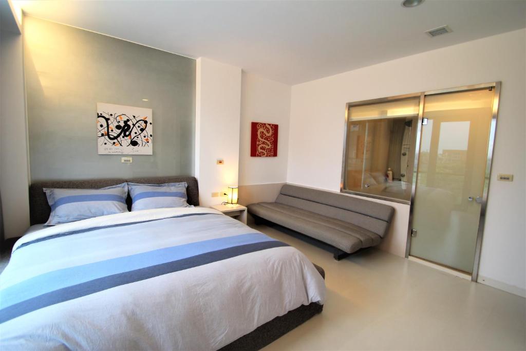 a bedroom with a large bed and a couch at The Designer&#39;s House in Wujie