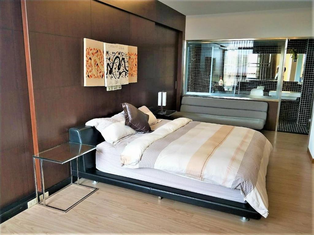 a bedroom with a large bed and a window at The Designer&#39;s House in Wujie